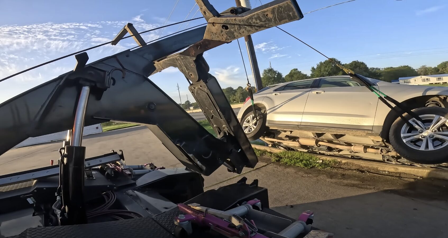Emergency towing truck loading damaged vehicle for 24/7 roadside assistance