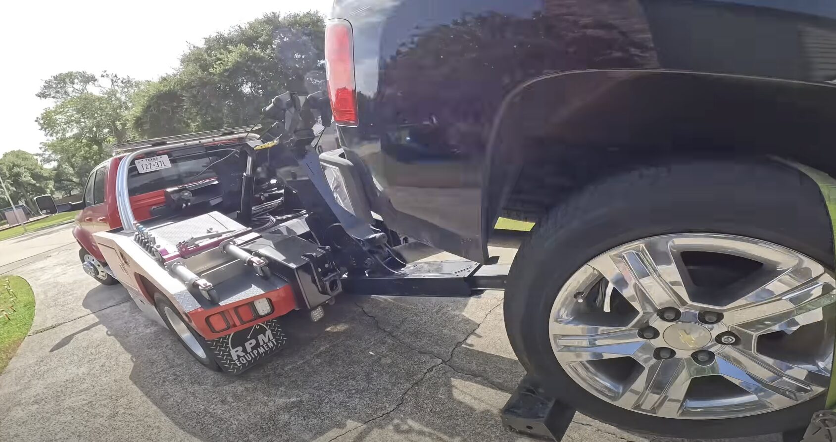 Emergency towing service in action - Woodridge Towing Service Professional tow truck loading a white sedan for emergency towing service in Woodridge, IL